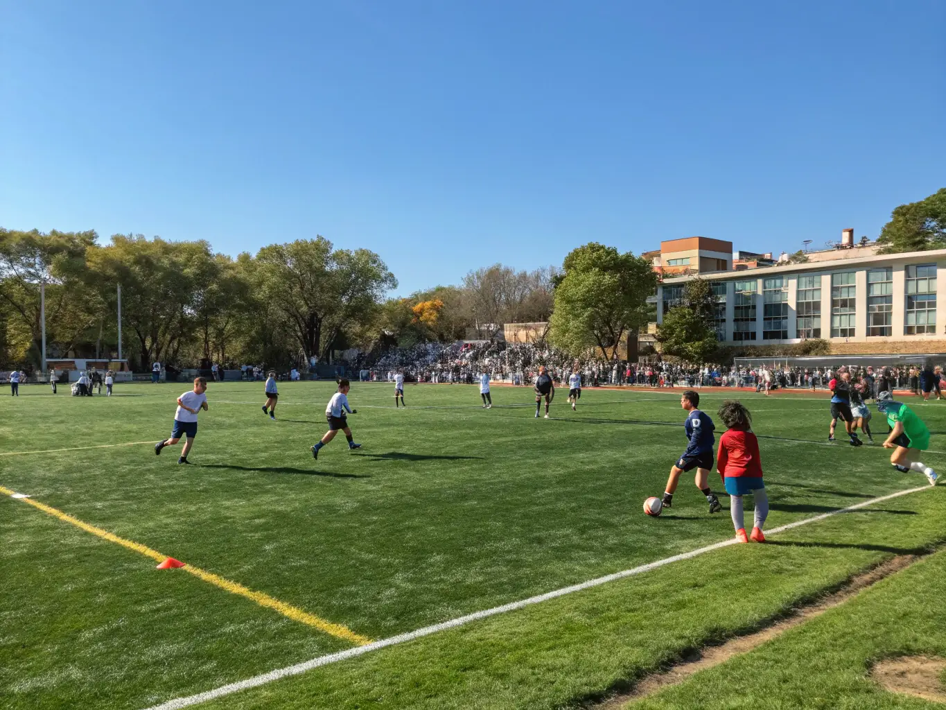 A wide shot of the sports field at Kosi National School with students playing various sports, highlighting the school's focus on physical fitness and teamwork.