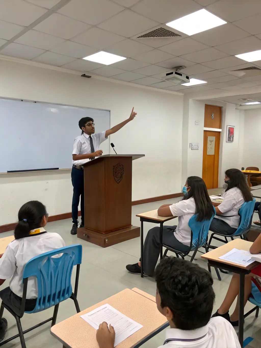 A group of students participating in a debate or public speaking event, highlighting the school's focus on communication skills.